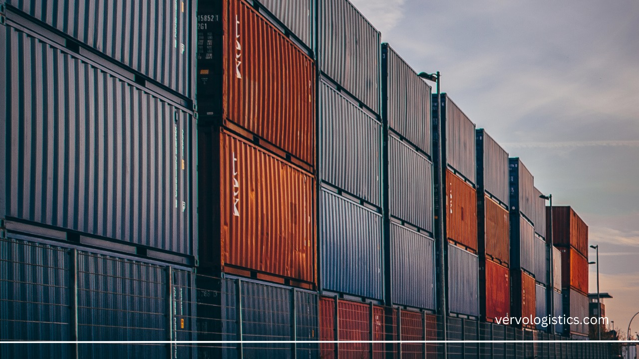 Cost Factors You Must Consider Before Shipping A Container, containers staked in a port ready to be loaded, image by vervo middle east for logistics solutions 